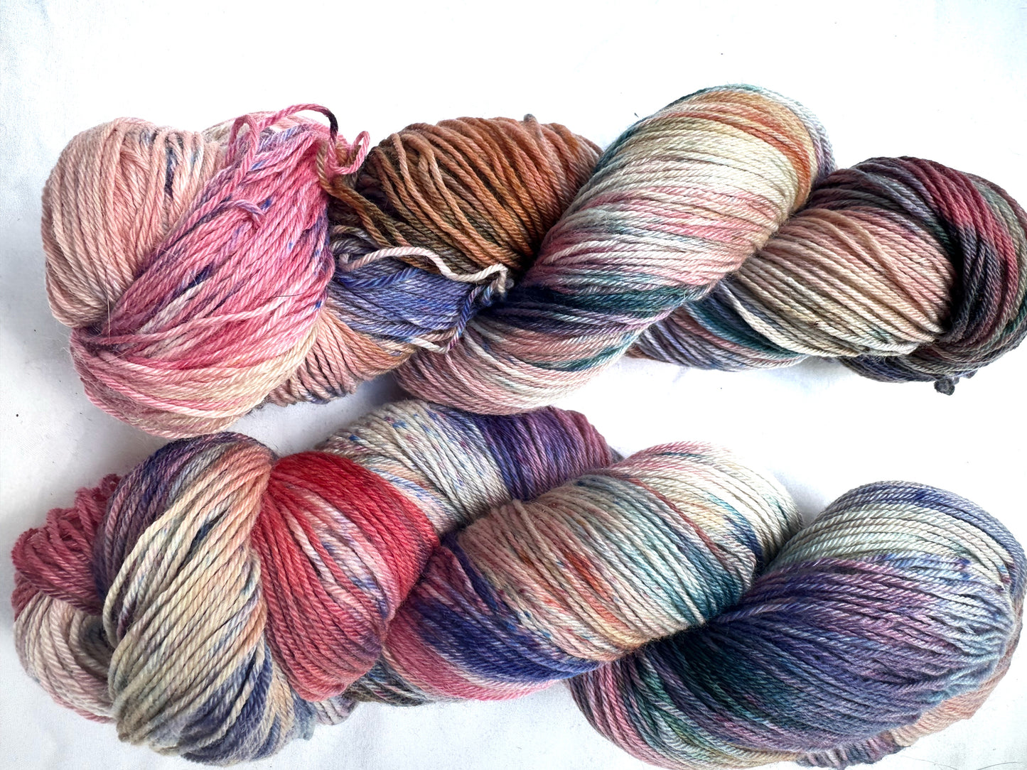 Variegated pink teal blue purple MCN fingering
