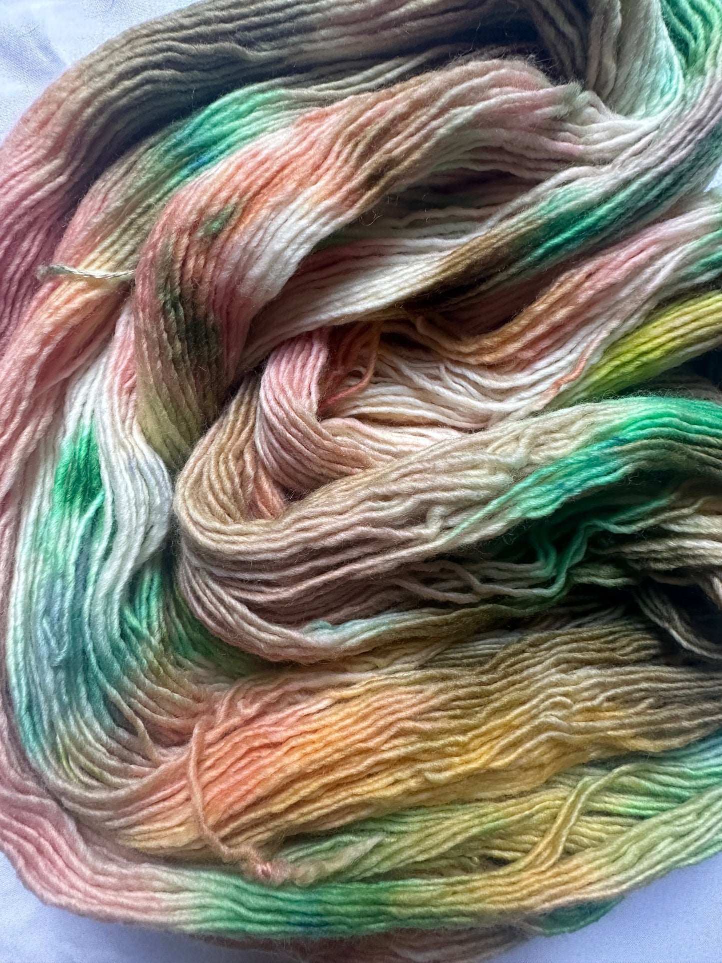 Fingering peach green variegated