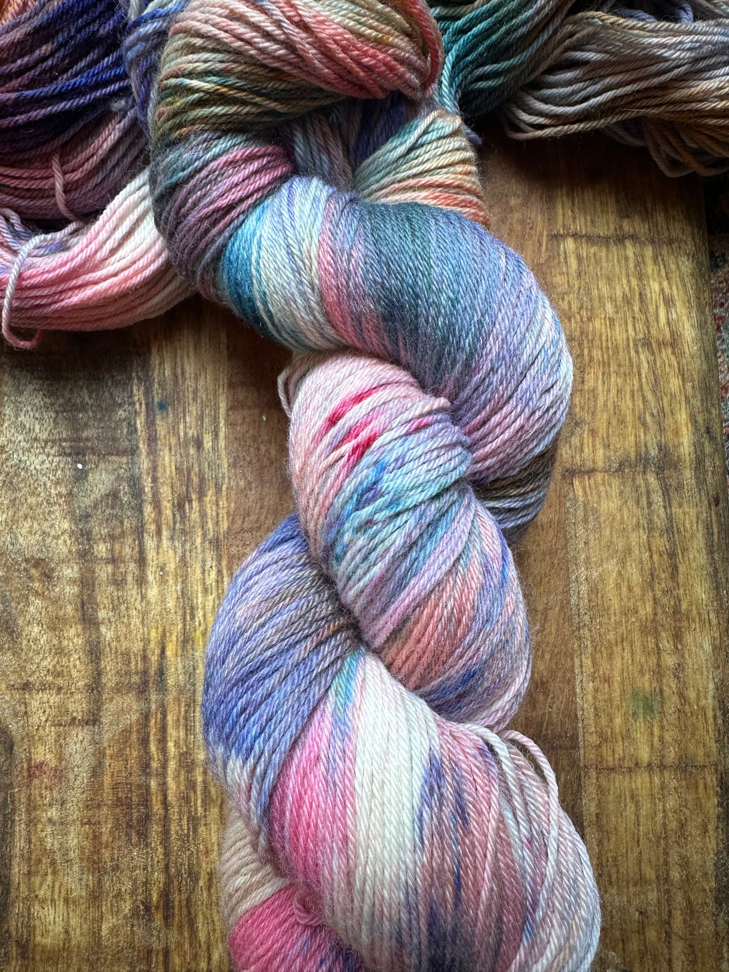 Variegated pink teal blue purple MCN fingering