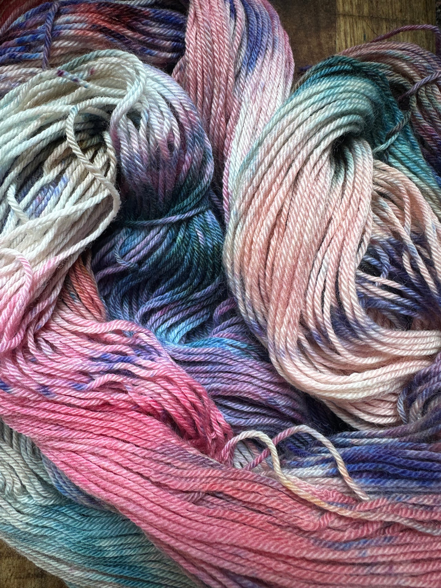 Variegated pink teal blue purple MCN fingering
